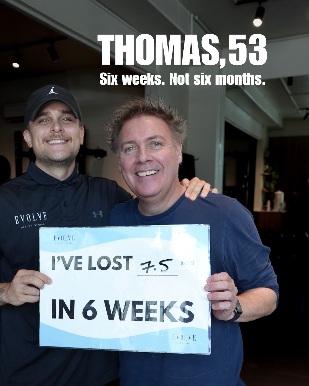 Thomas holding a sign showing 7.5 kg lost